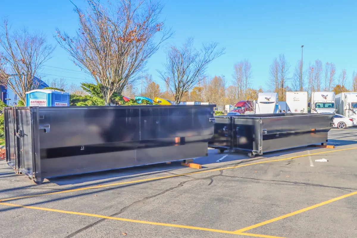 Professional dumpster rental service with roll-off container on residential driveway in Town of Pecos